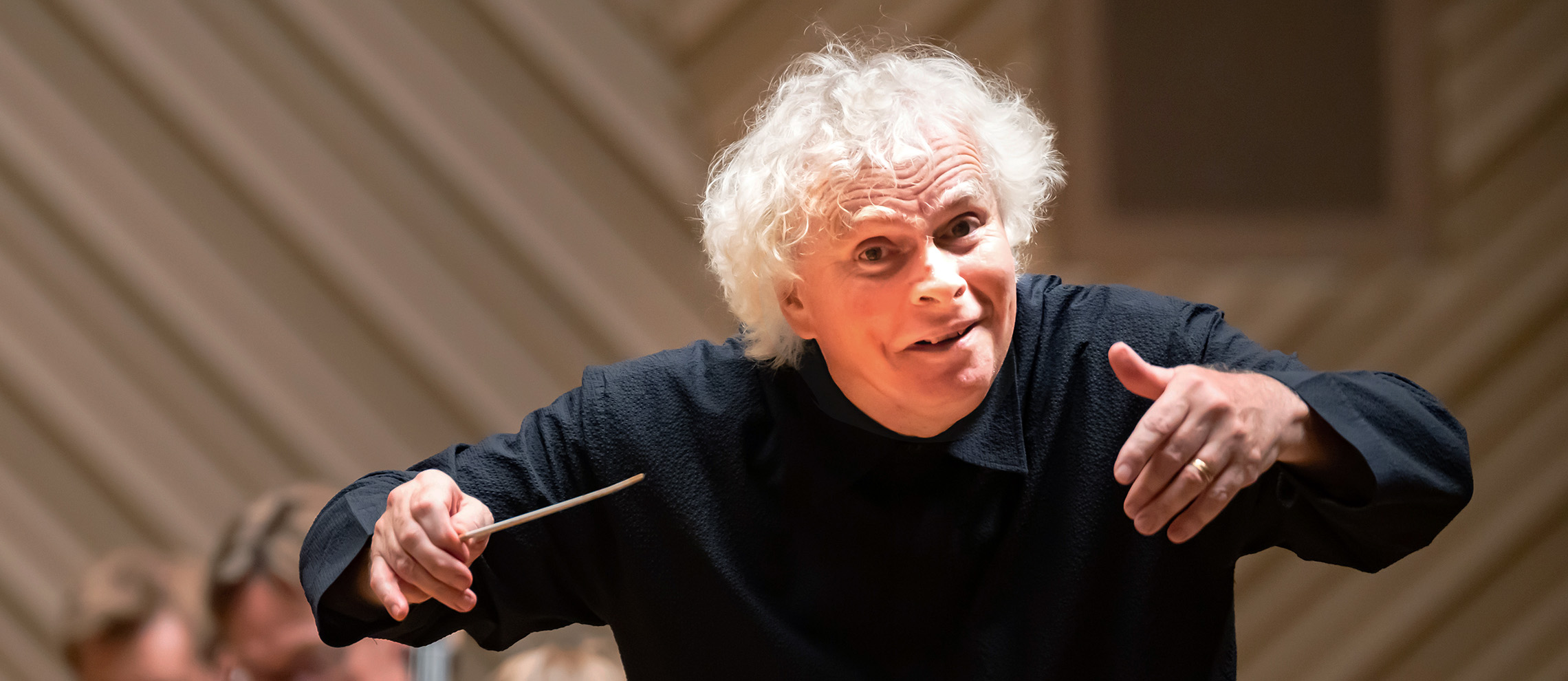 Sir Simon Rattle conducting